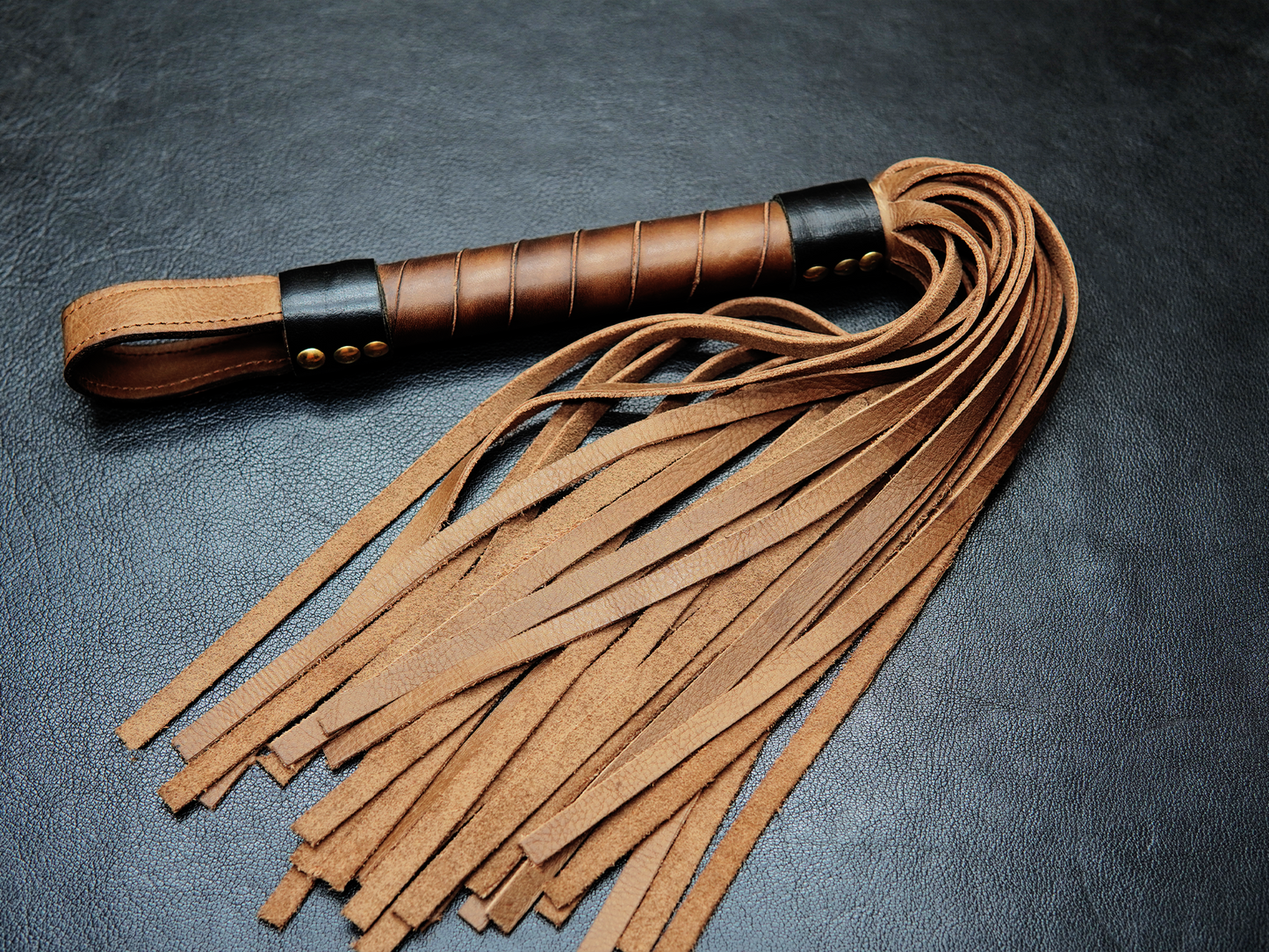 Brown Full view of Fits Flogger by Bovidas – leather flogger with braided handle and soft falls"
