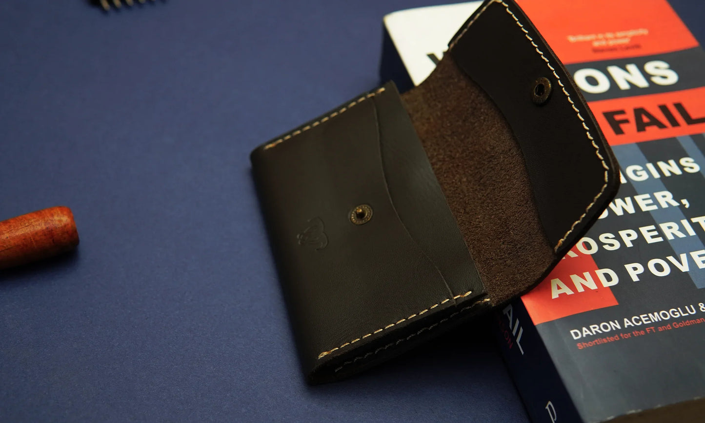 Premium leather card holder with two slots and a cash compartment.