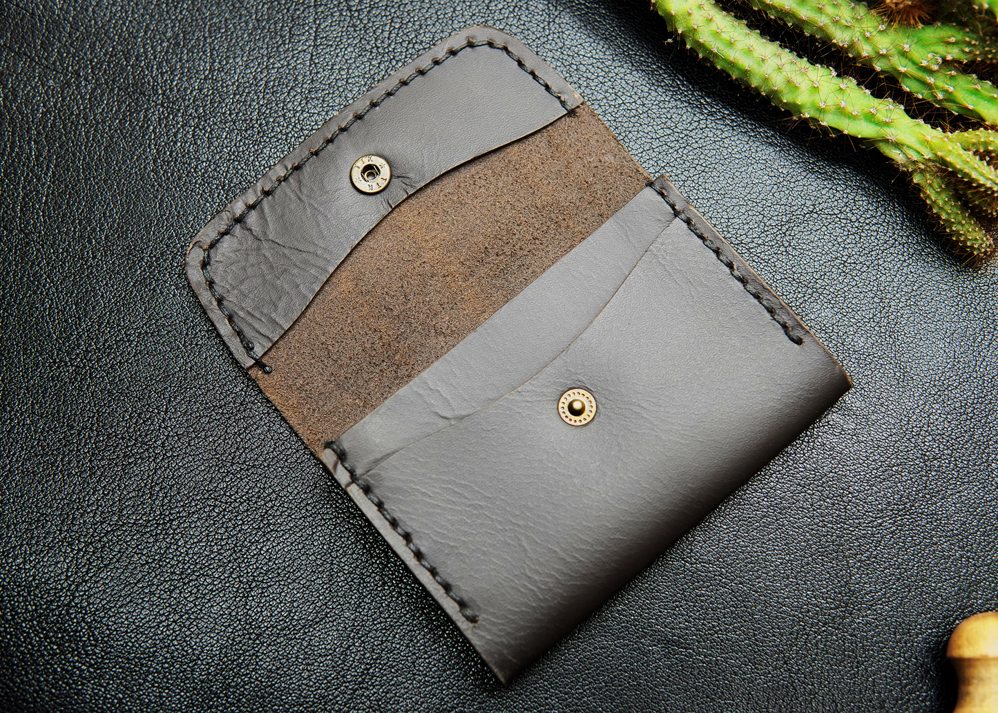 Stylish dark grey leather card holder with 2 card slots.