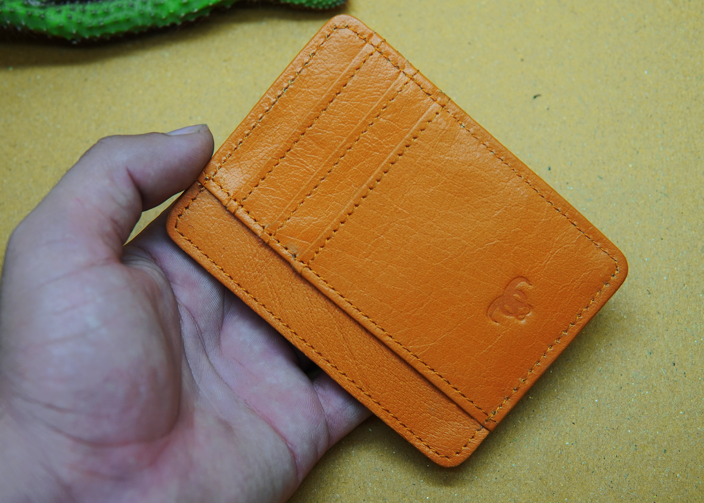 Orange leather card holder with a modern design – ideal for professionals and trendsetters