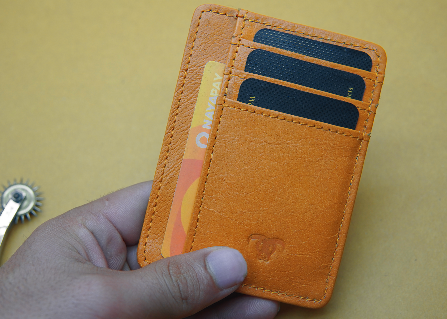 "Slim and elegant orange card holder wallet design, crafted from high-quality leather."