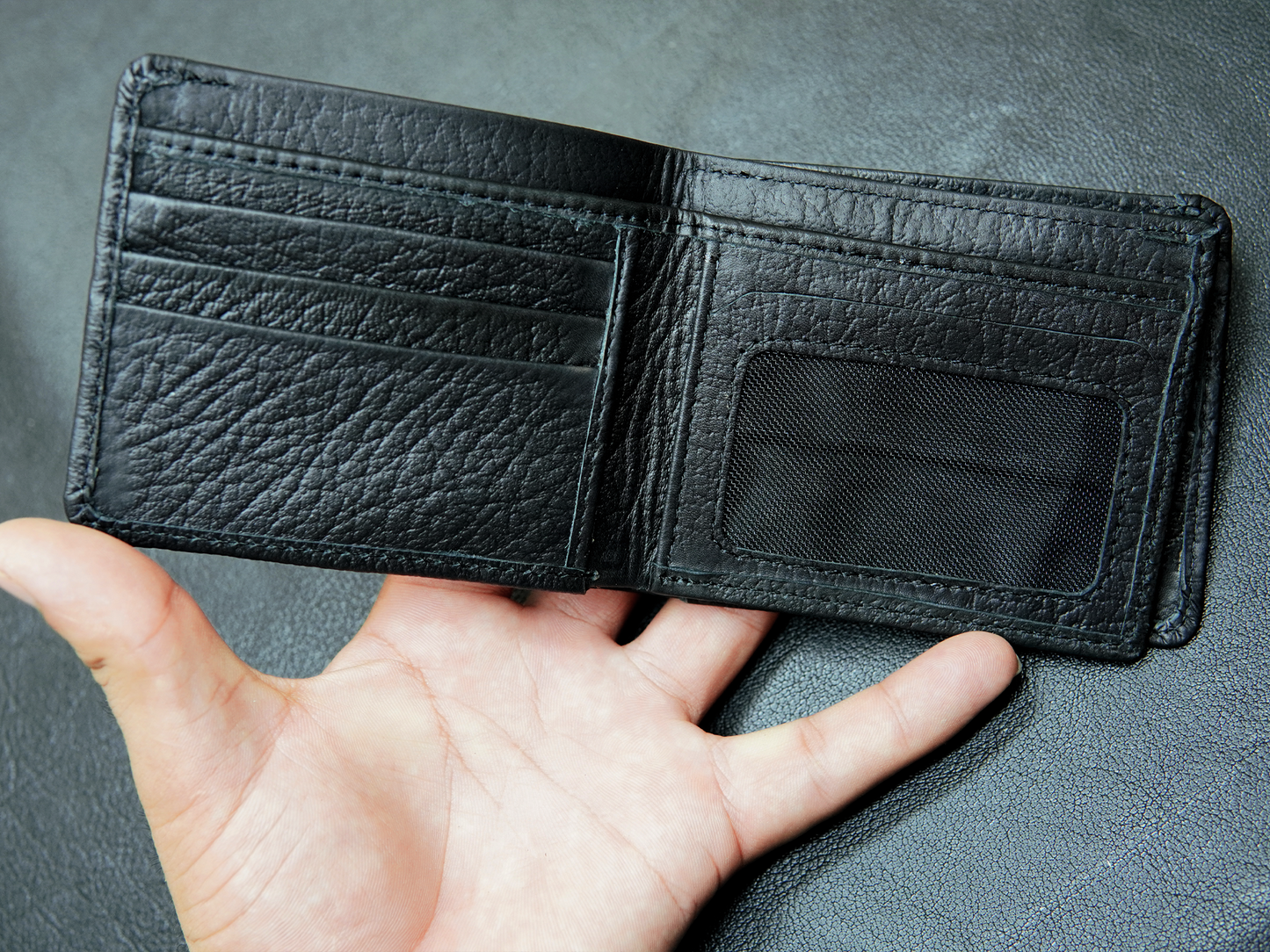 Inside view of Bovidas black bifold wallet showing card slots, and ID windows