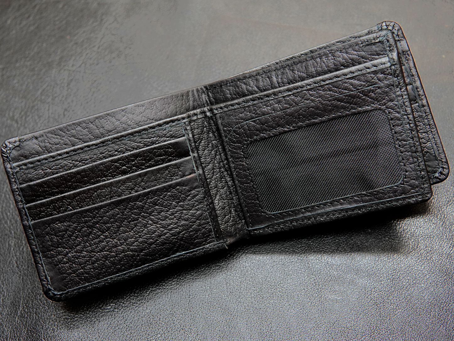 Inside view of Bovidas black bifold wallet showing card slots, and ID windows