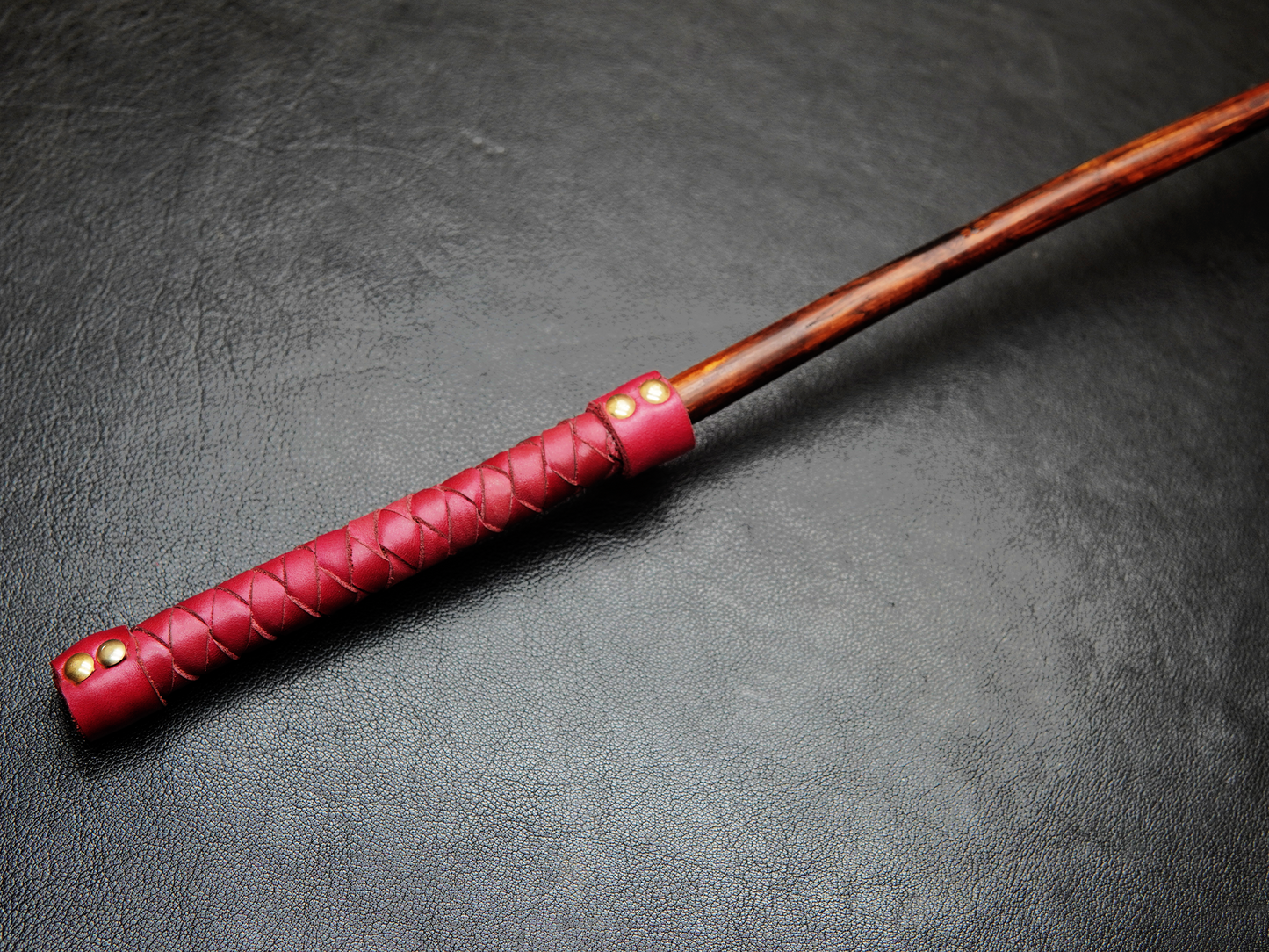 Close-up of Bovidas Whip wooden handle with grip wrap
