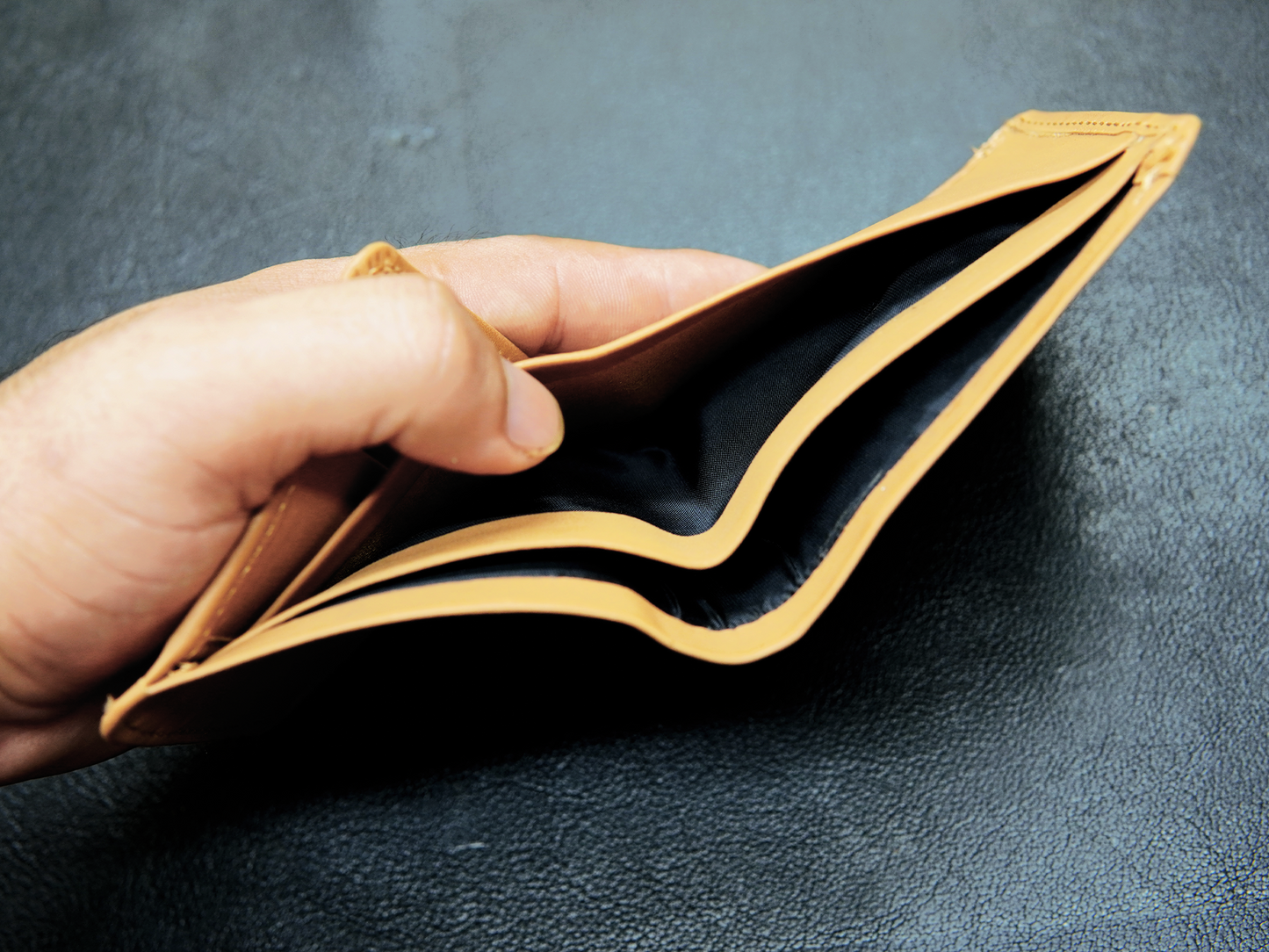 Open view of trifold wallet showing dual cash compartments