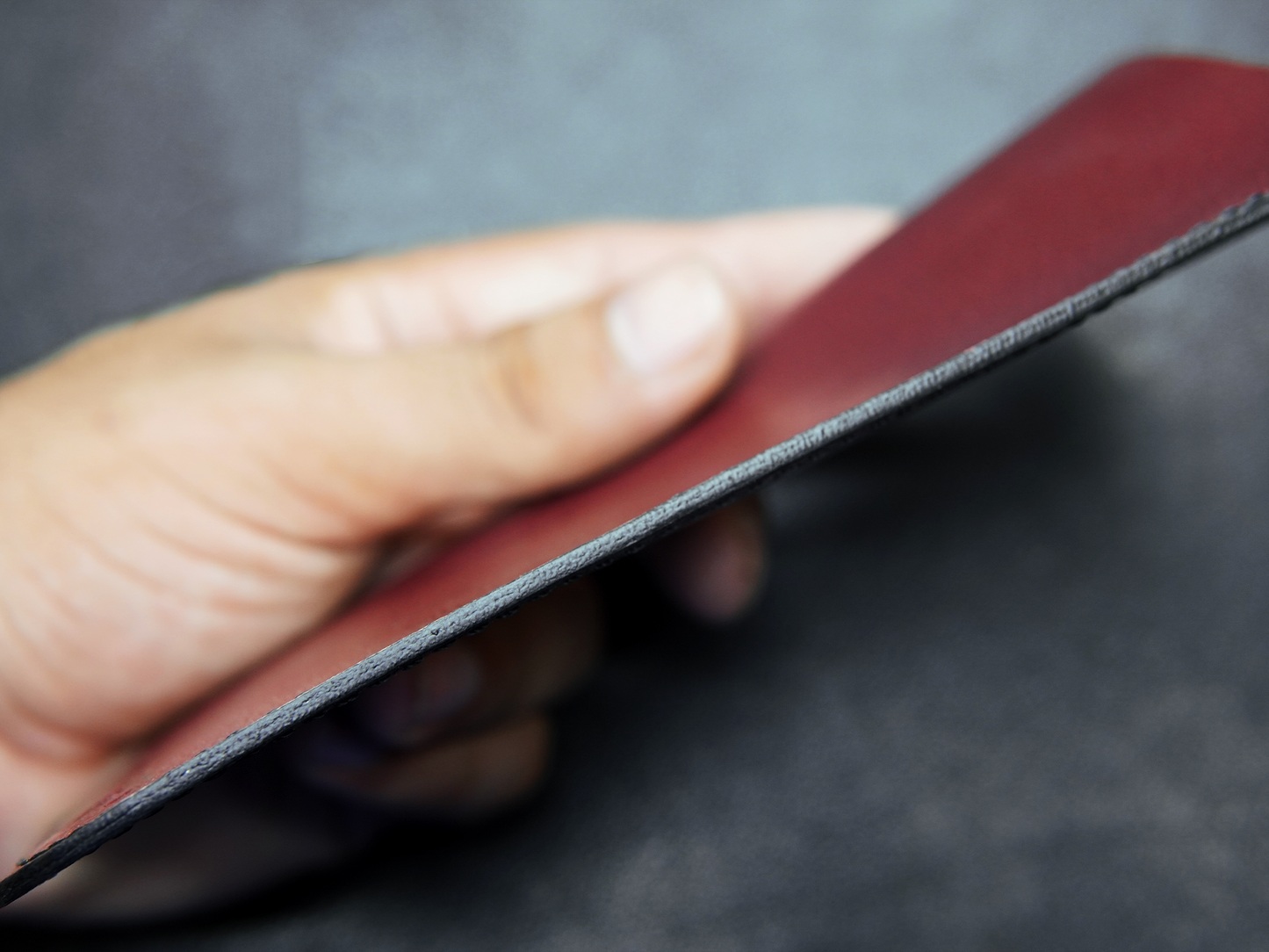 Close-up of good finishing on red leather glasses case