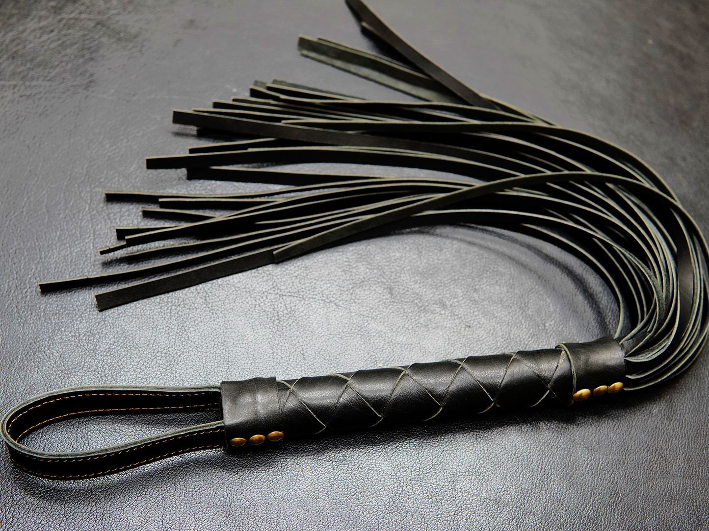 Full view of Fits Flogger by Bovidas – leather flogger with braided handle and soft falls