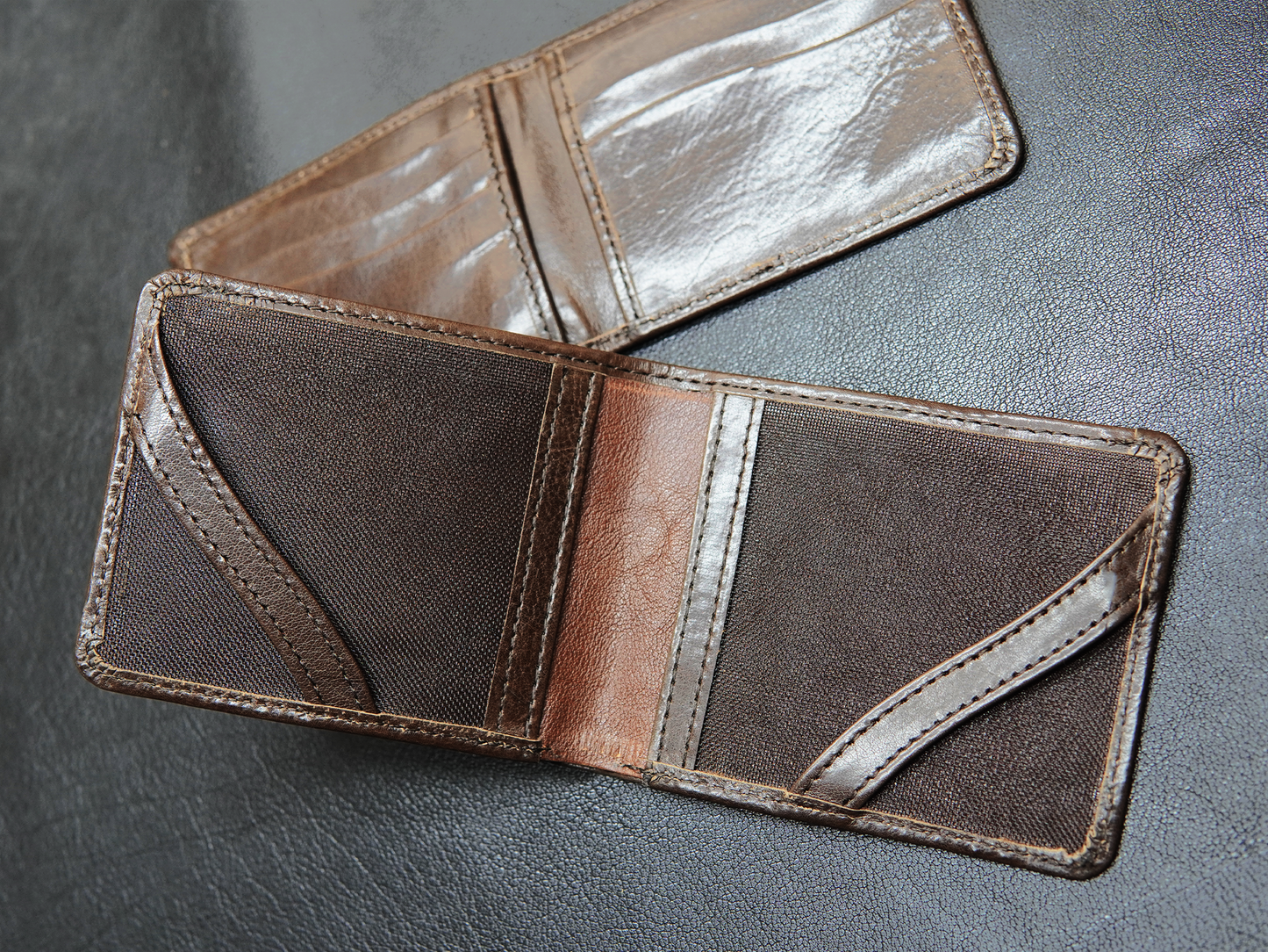 Close-up of hidden pockets beneath card slots inside FoldClassic leather wallet