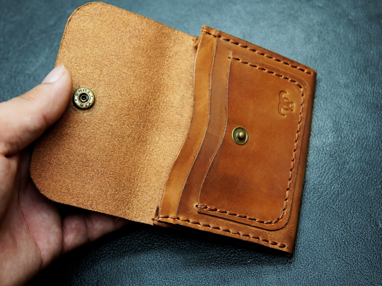 Handcrafted leather card wallet held in hand – slim, durable, and perfect for minimalist everyday use.