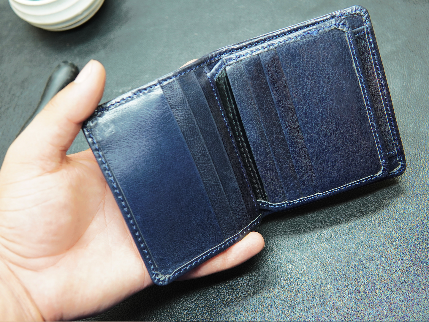 Open blue leather wallet with 6 card slots