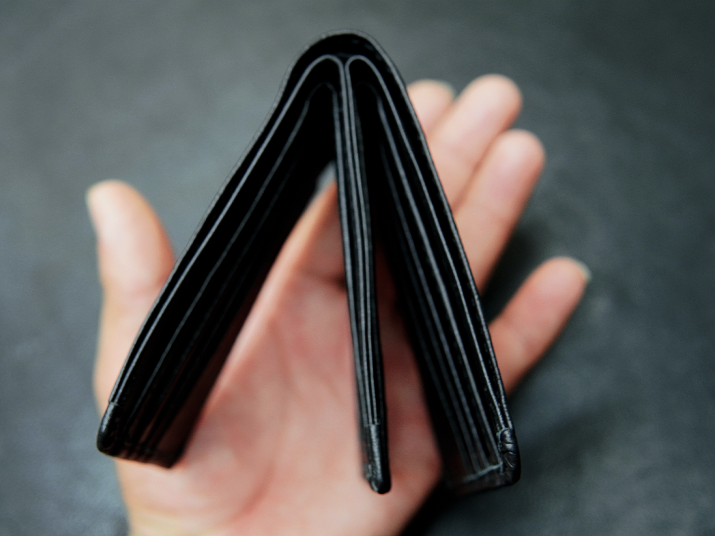 Close-up of Bovidas Shadow Wallet’s premium black leather edge finish