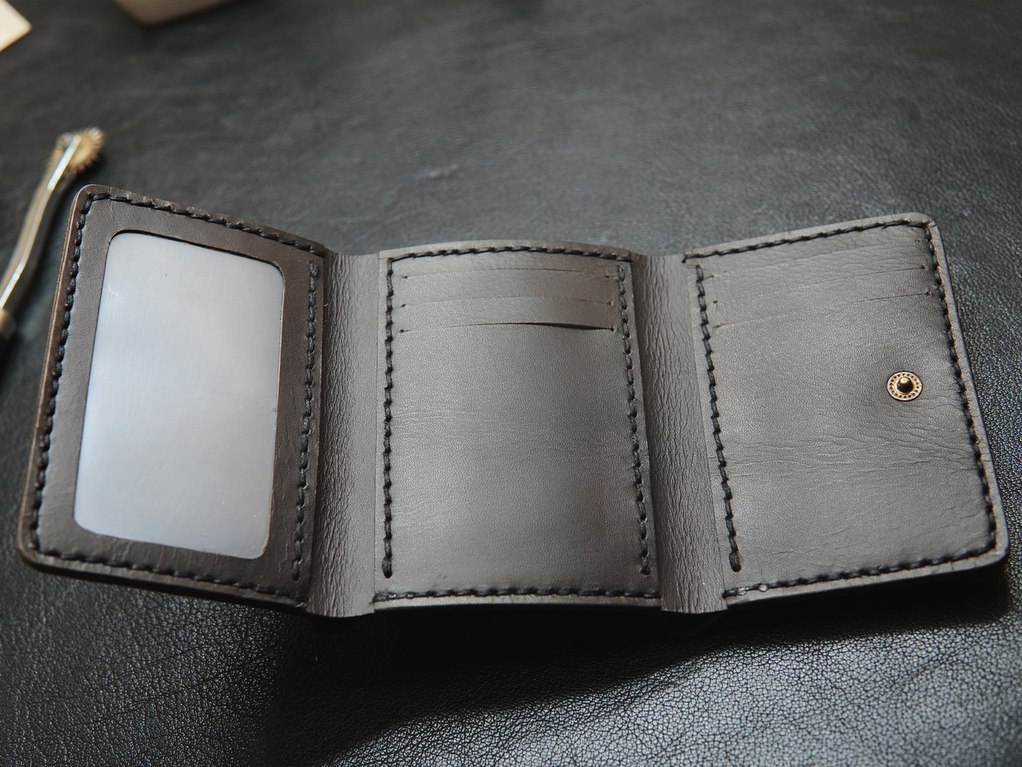 Inside view of Trinity wallet featuring 3+3 card slots, clear ID window, and hidden compartments.