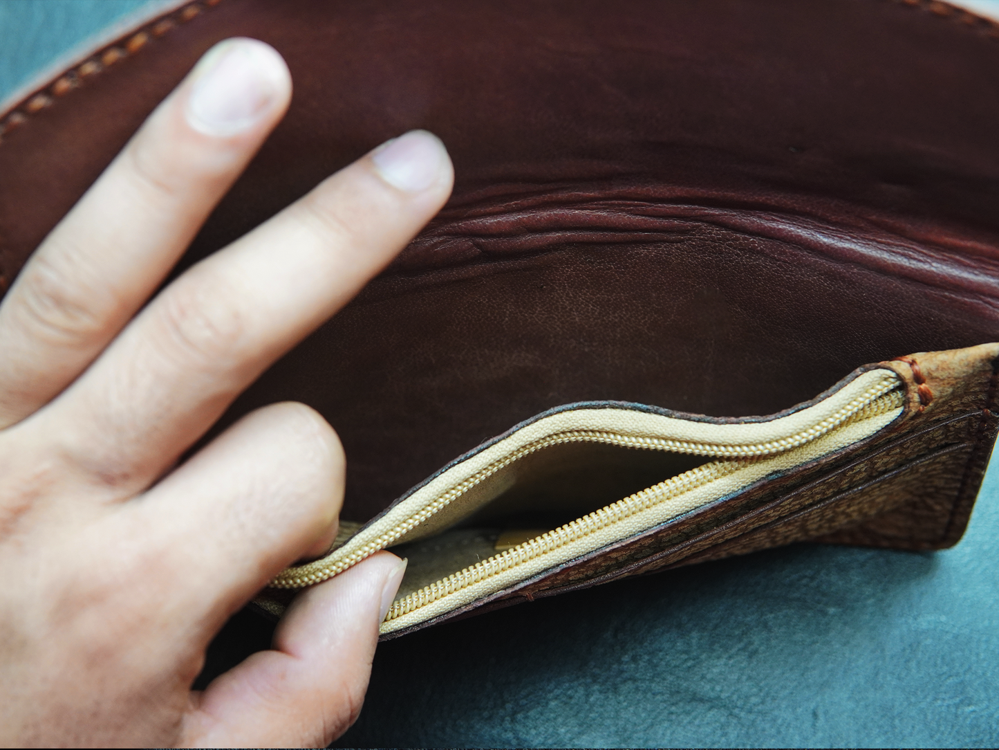 Inside view of Bovidas Luna clutch showing zip pocket, main compartment for phone, cash, and essentials