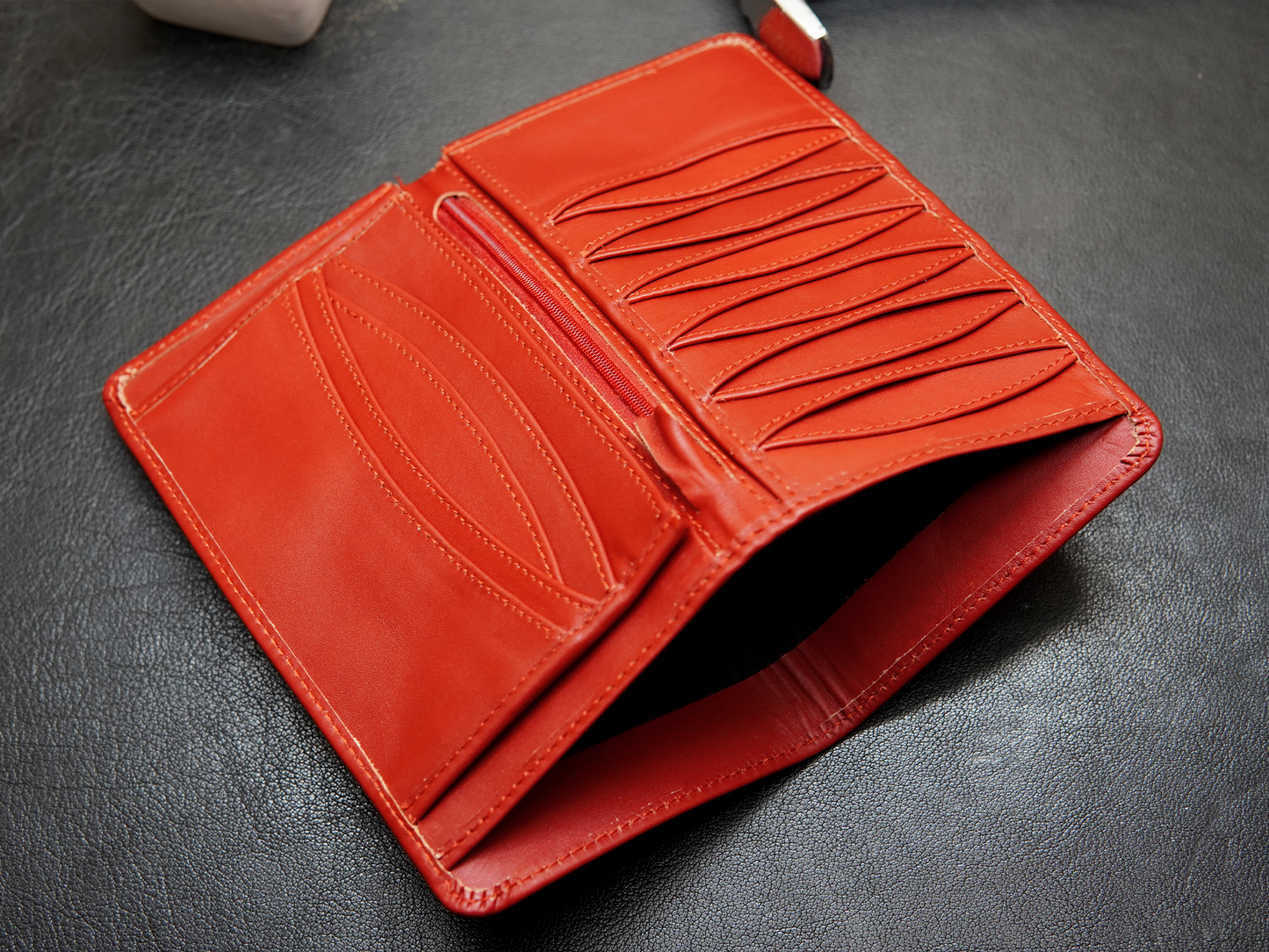 Red leather wallet with multiple card and cash slots