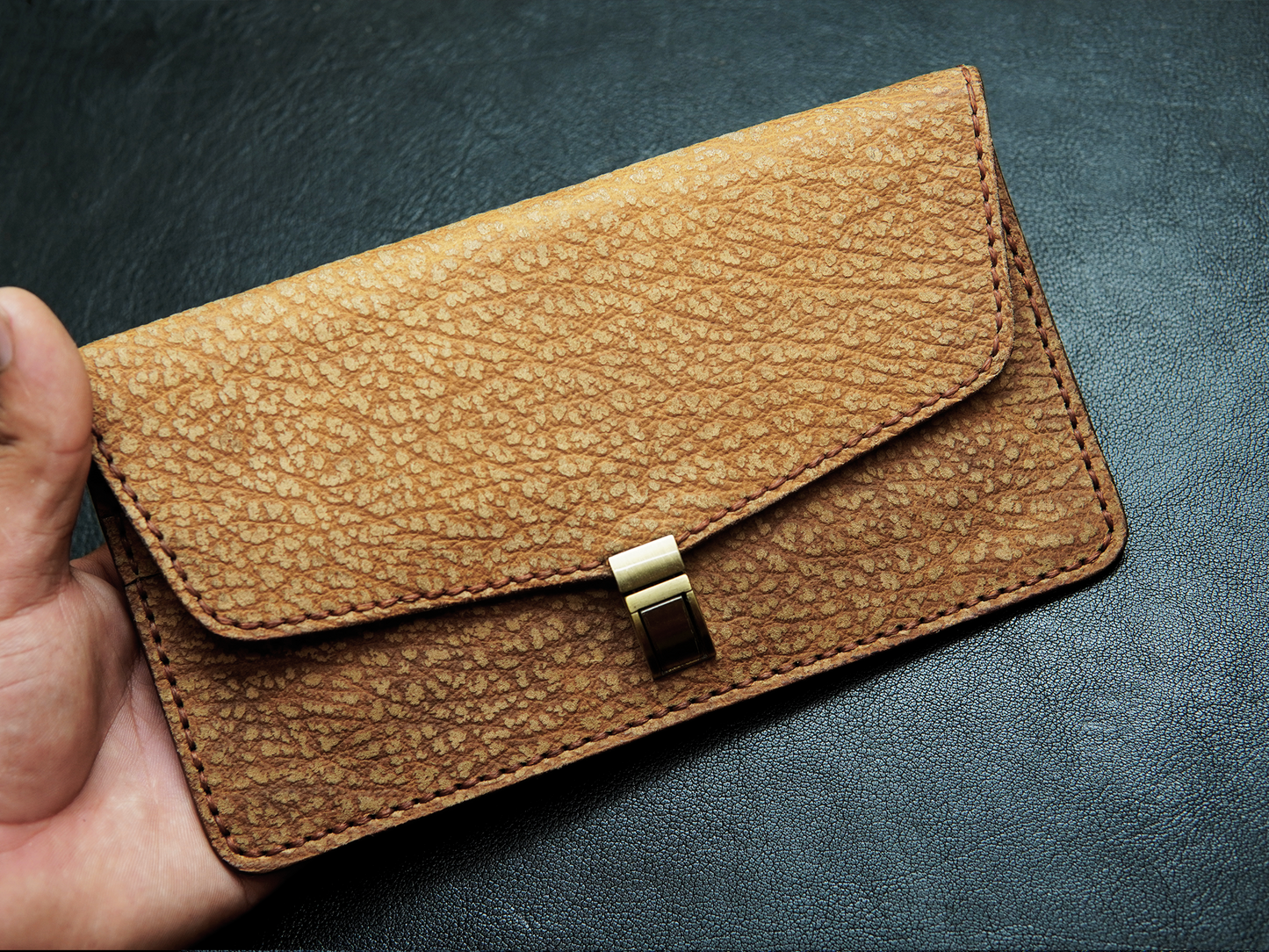 Luna brown leather clutch in hand – ideal for shopping, brunch, or casual outings