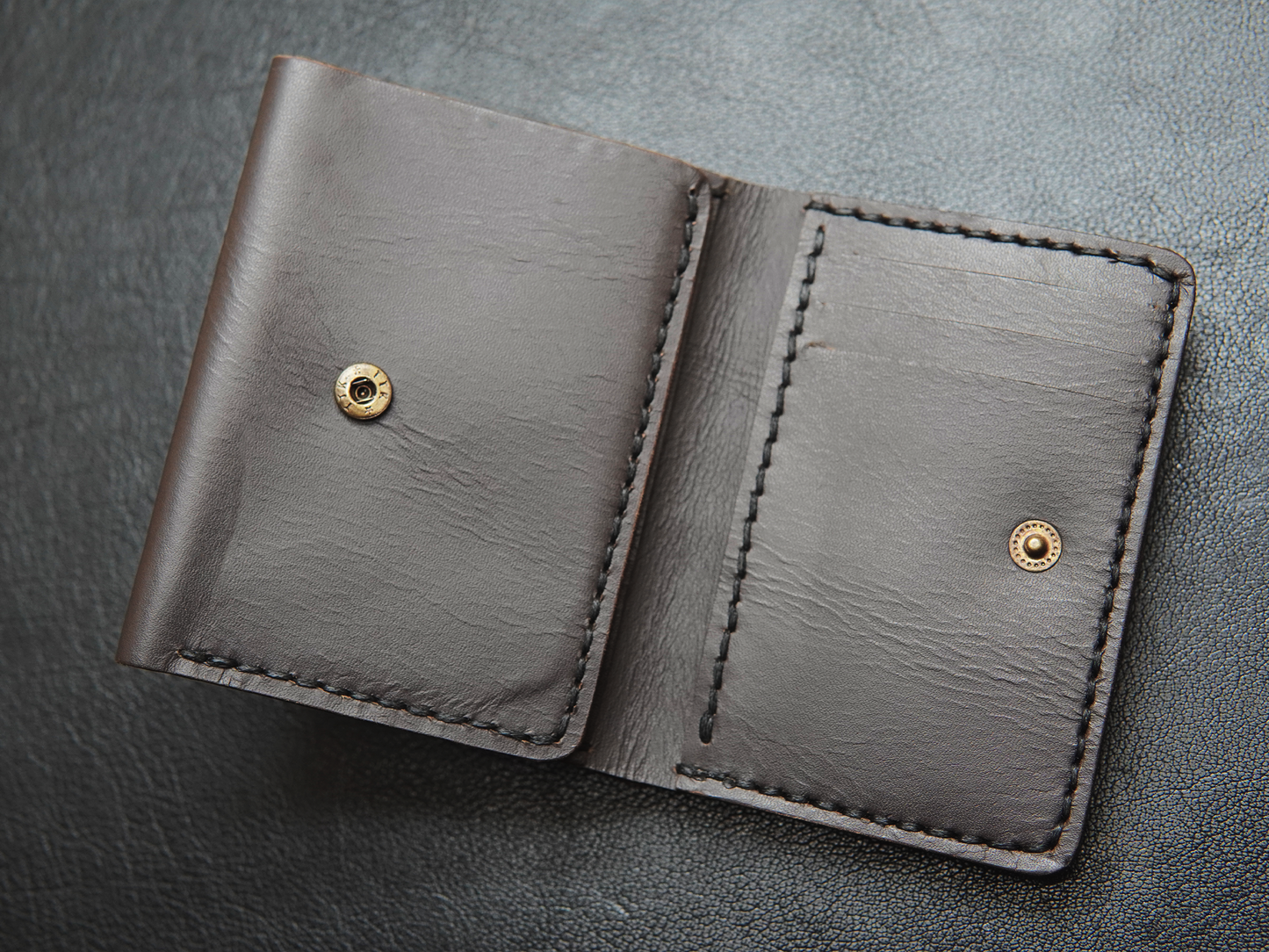Close-up of snap-button closure on Trinity handmade wallet for secure everyday carry.