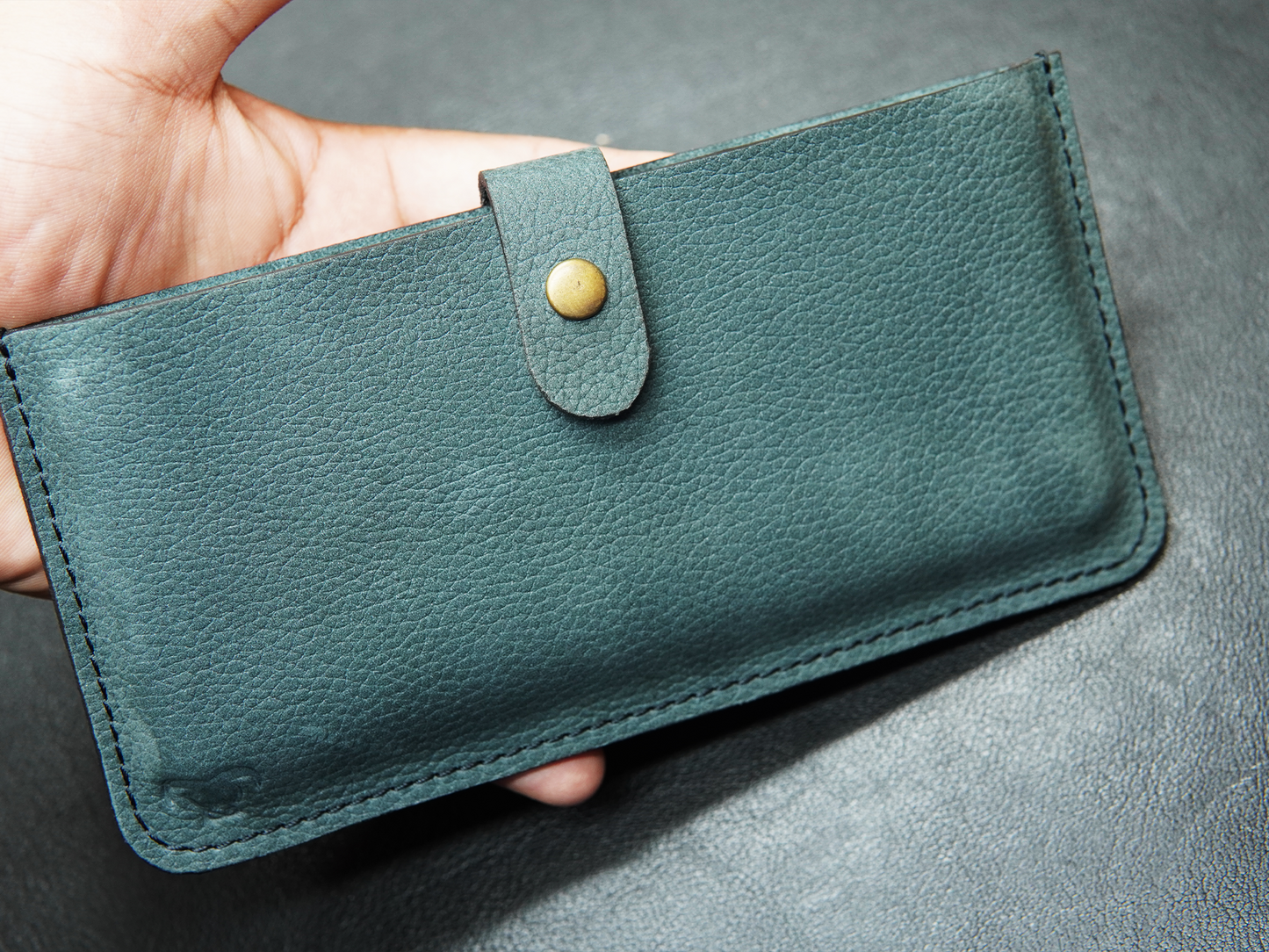Bovidas Verde Pocket pouch held in hand showing compact size and fit