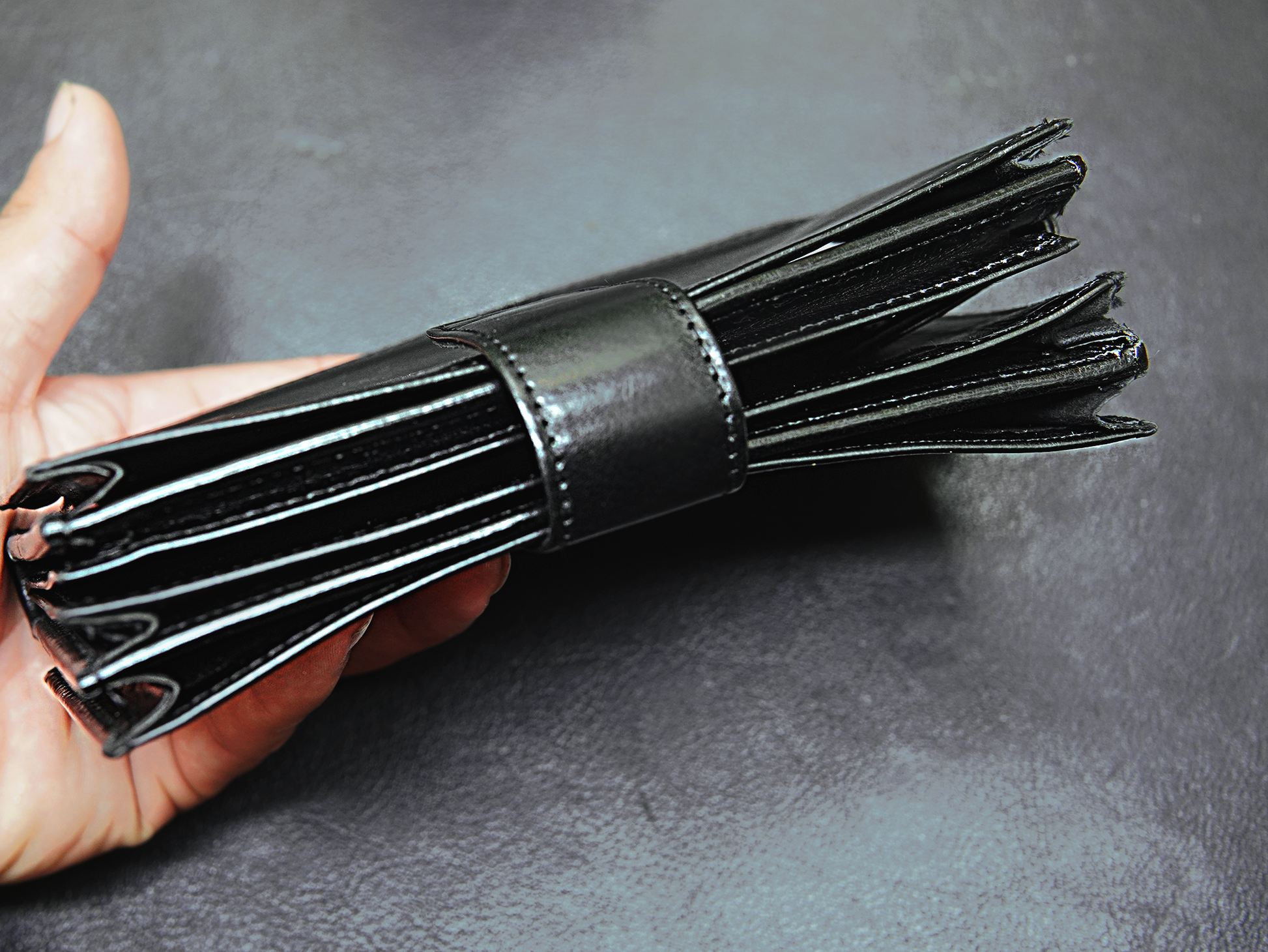 Black leather wallet held in a hand 