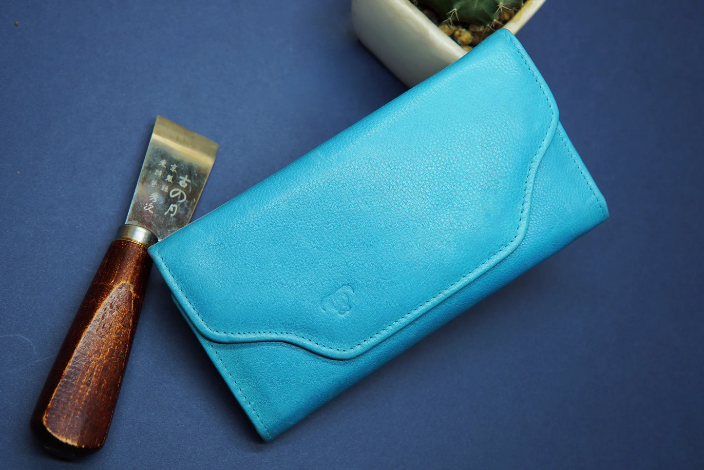Sky blue long leather wallet with a sleek and modern design.