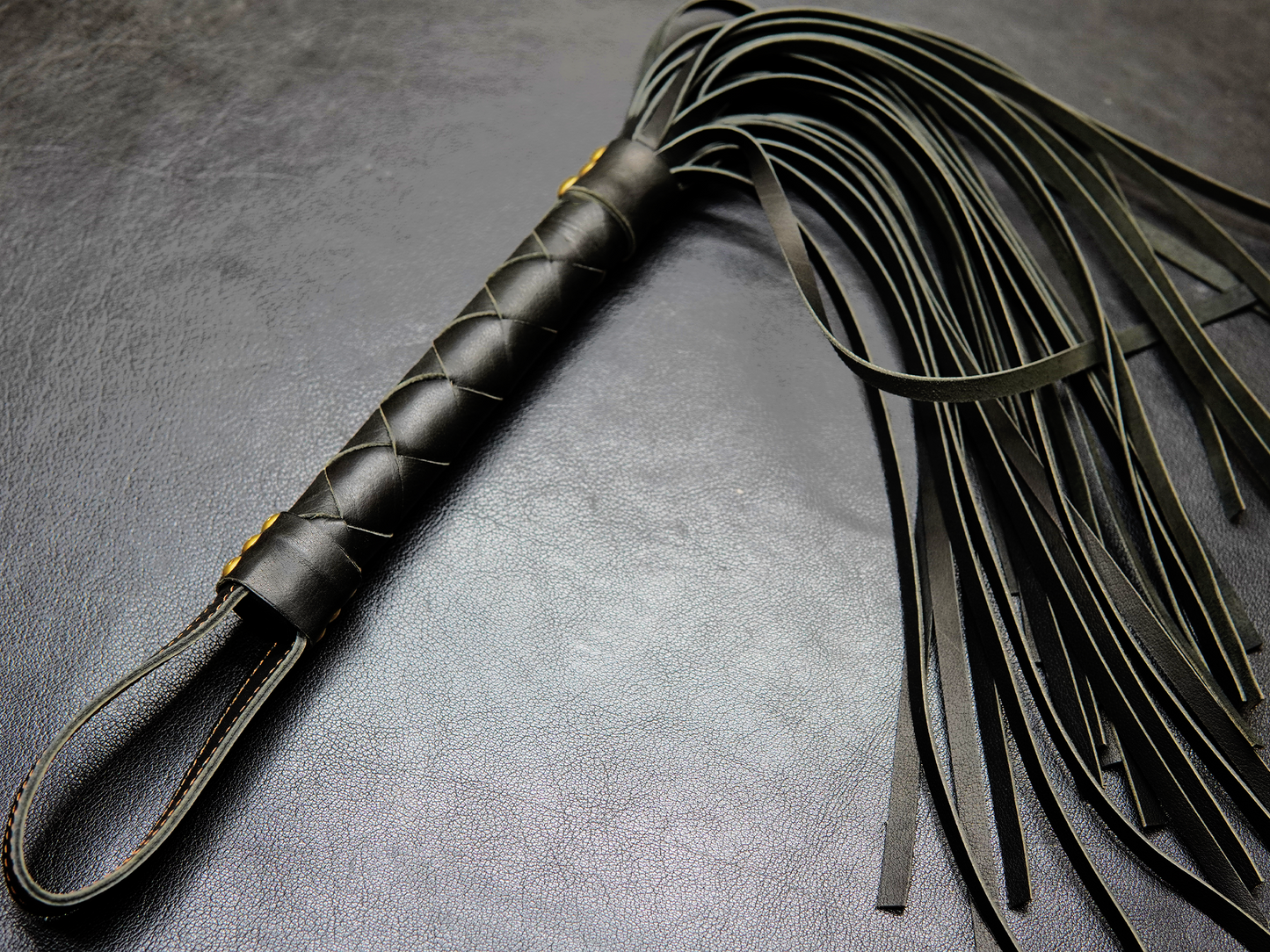 Full view of black Fits Flogger by Bovidas – leather flogger with braided handle and soft falls