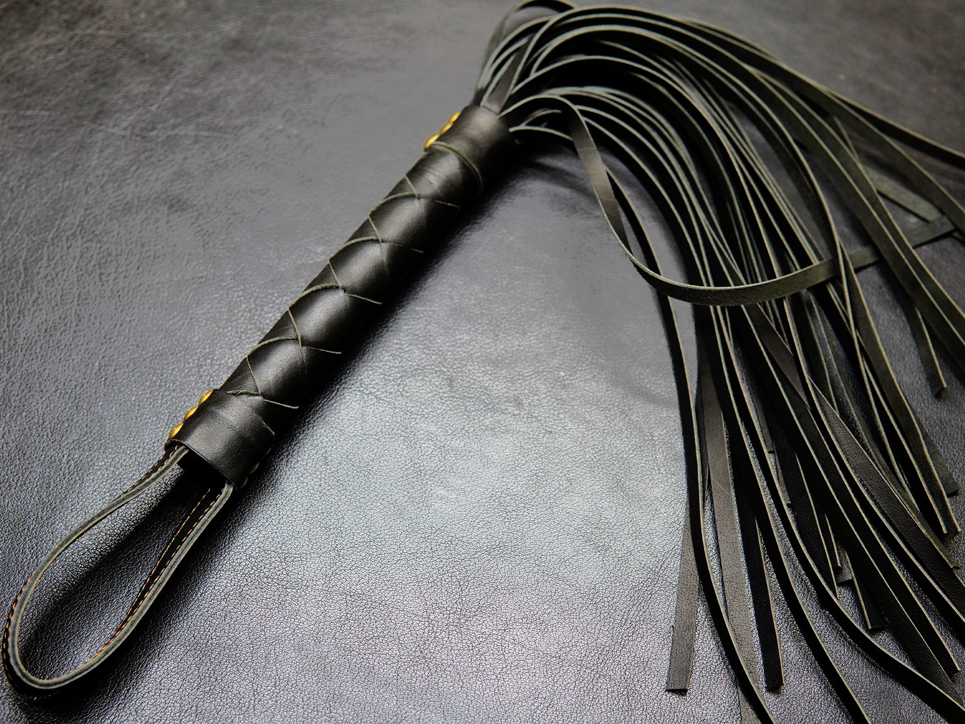 Full view of black Fits Flogger by Bovidas – leather flogger with braided handle and soft falls