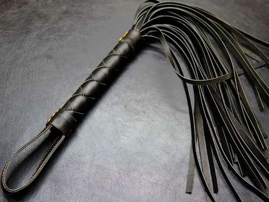 Full view of black Fits Flogger by Bovidas – leather flogger with braided handle and soft falls