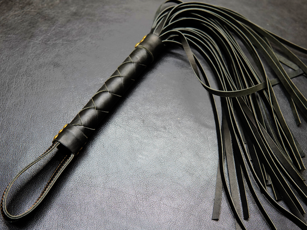 Full view of black Fits Flogger by Bovidas – leather flogger with braided handle and soft falls