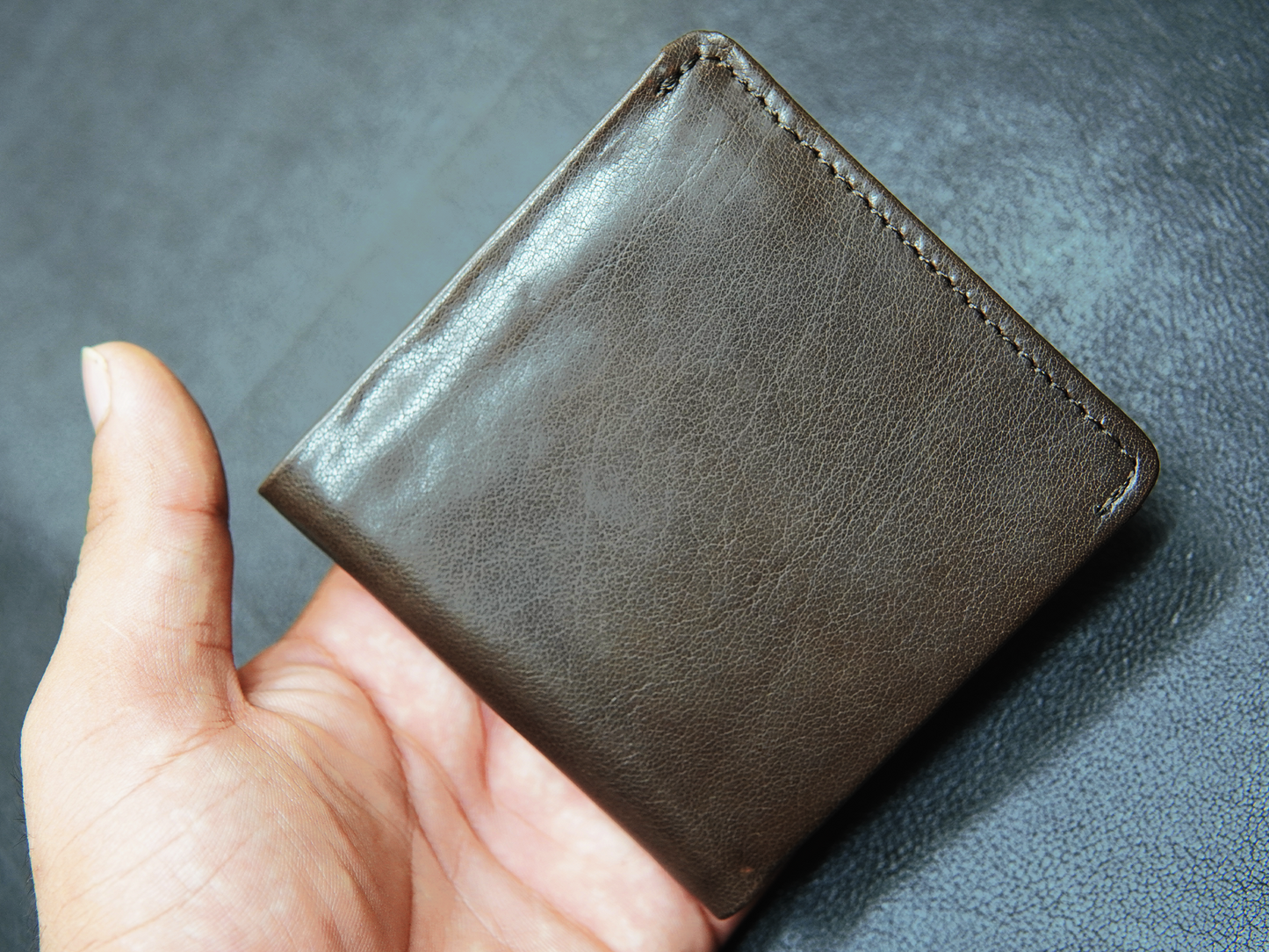  men's trifold dark brown leather wallet with clean stitching and minimalist profile