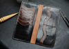 Premium black and brown leather long wallet with 12 card slots and spacious compartments

