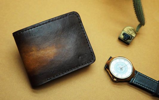 Elegant bifold leather wallet with dual-tone contrast, offering six card slots and a spacious cash compartment.

