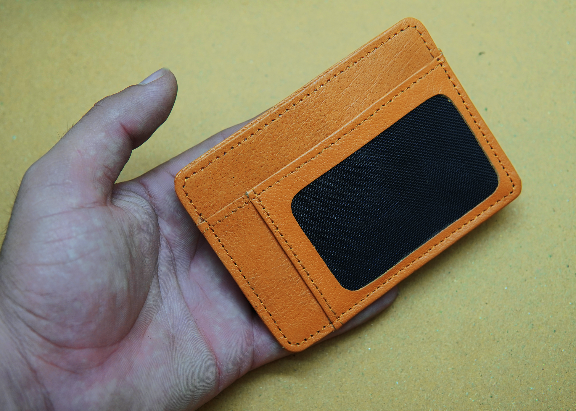 "Orange leather wallet with a modern design – ideal for professionals and trendsetters."

