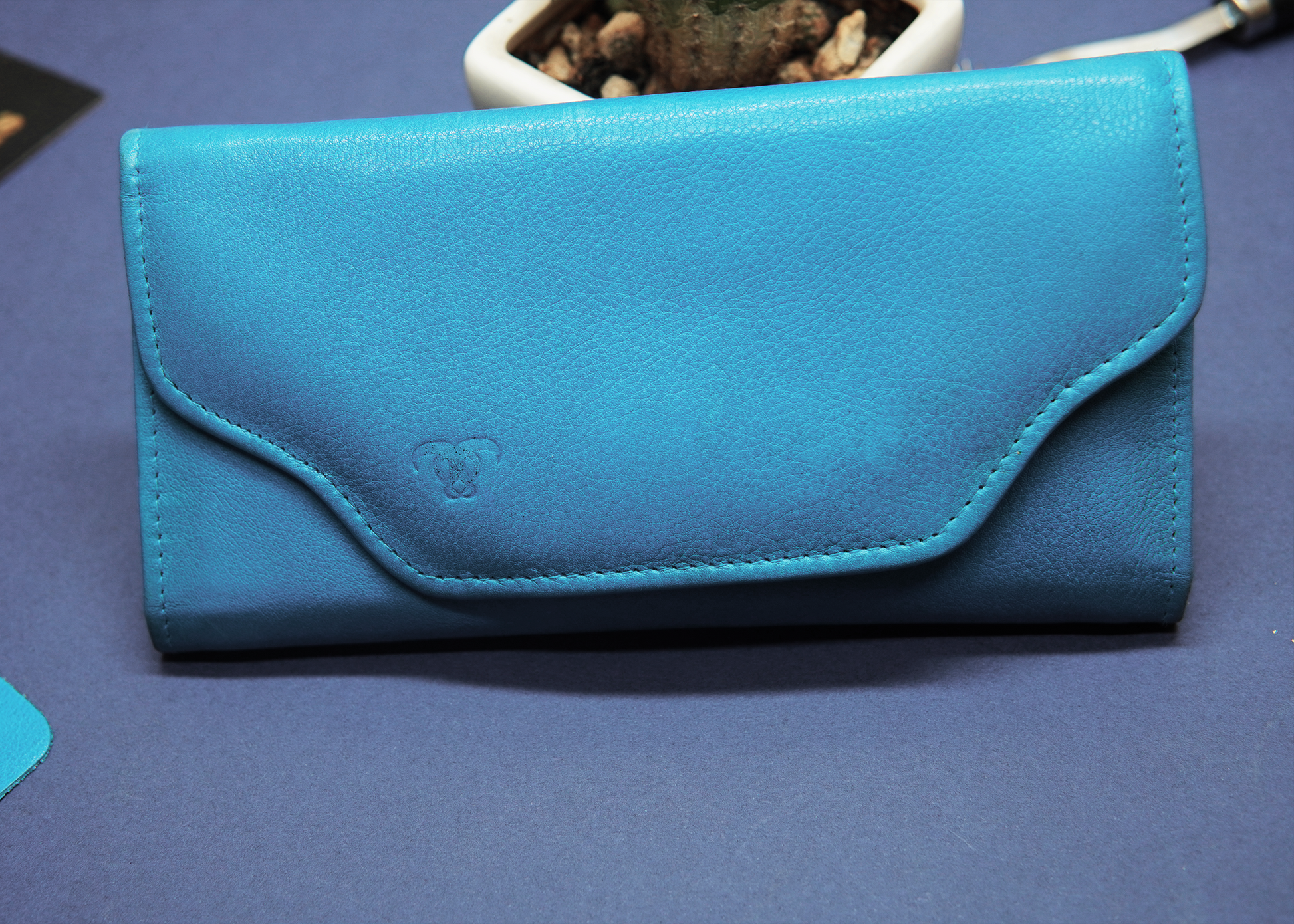  Sky blue long leather wallet with a sleek and modern design.