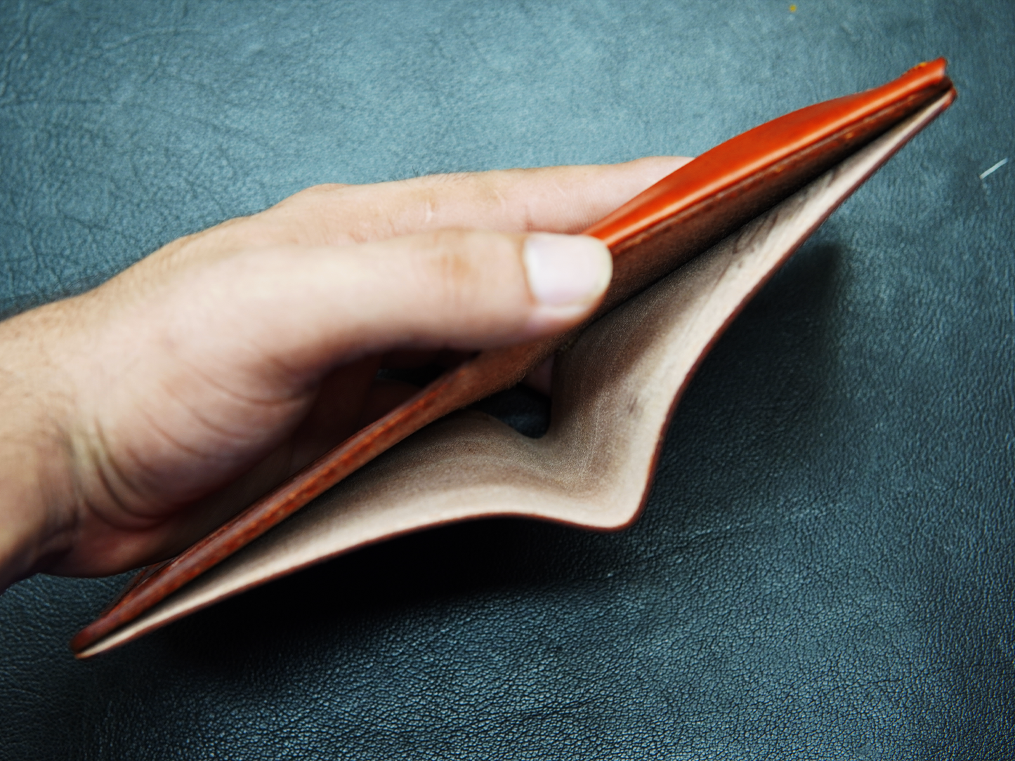 Open view of WildHorn brown leather wallet showing cash compartment"