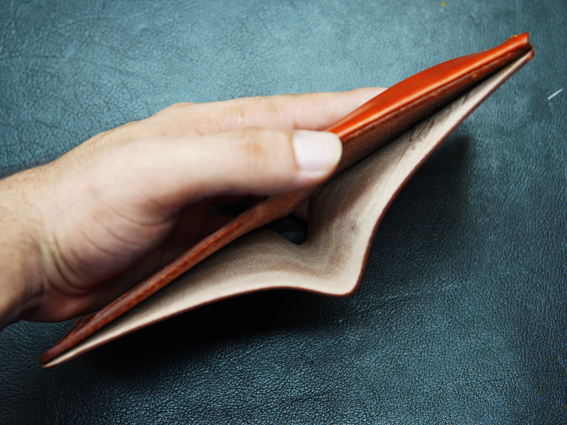 Open view of WildHorn brown leather wallet showing cash compartment"