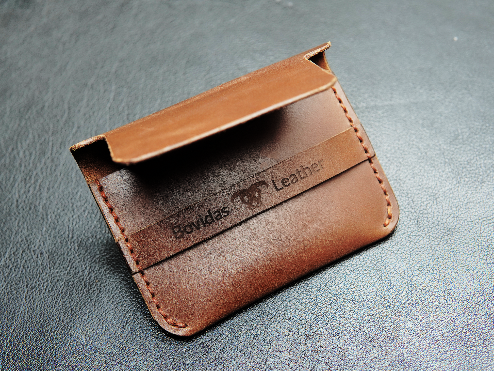 Brown leather card holder with fold-over flap"