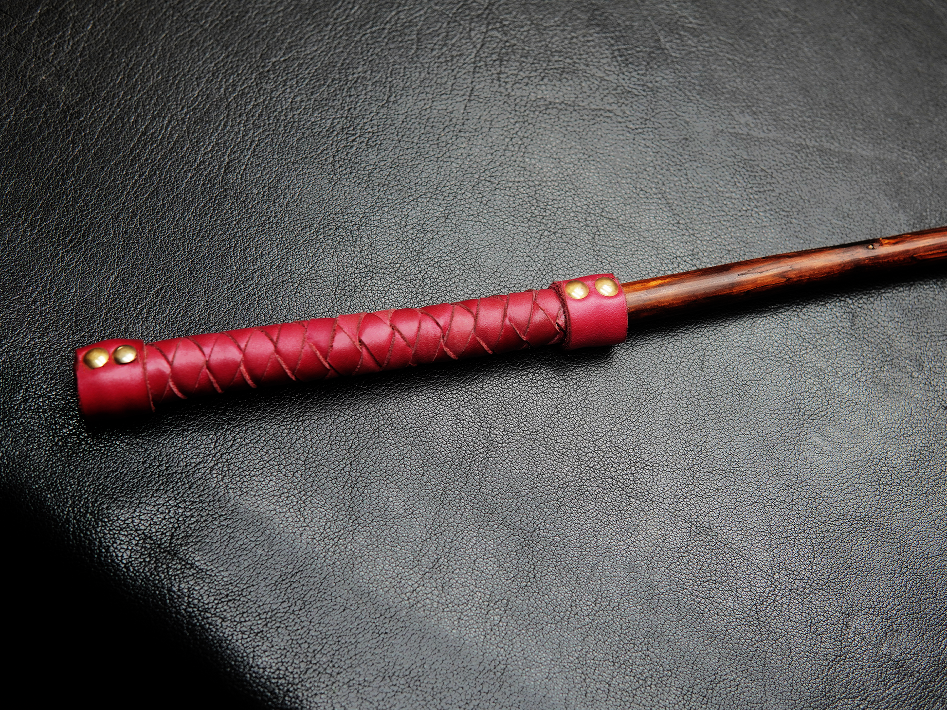 Close-up of Bovidas Whip wooden handle with grip wrap