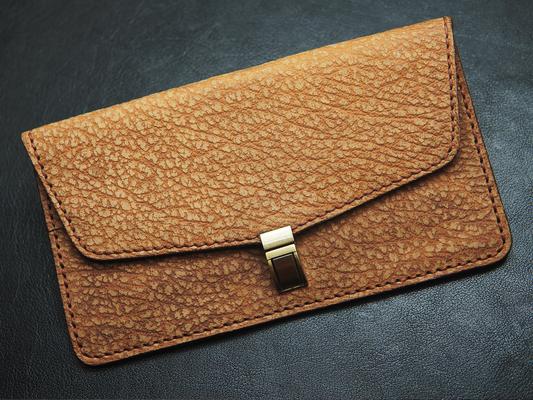 Bovidas Luna brown leather clutch for women with textured finish and elegant design



