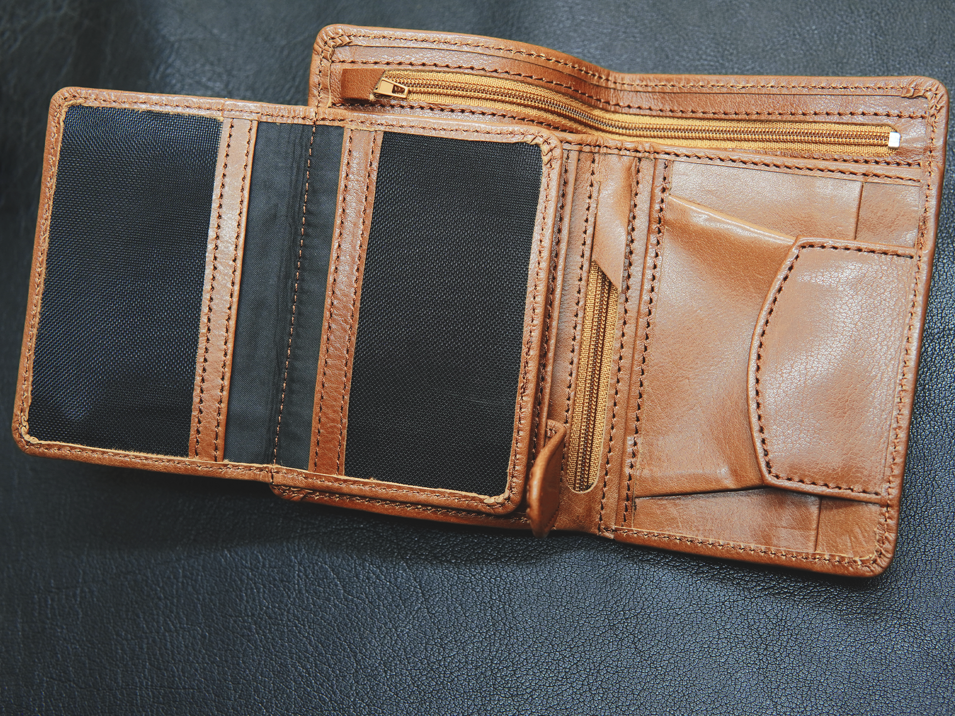 	"BOVIDAS CoreFold wallet open view – showing 2 ID comaprtment, 1 small zip  for valuable, 1 zipper full lenght  cash compartment and button slot