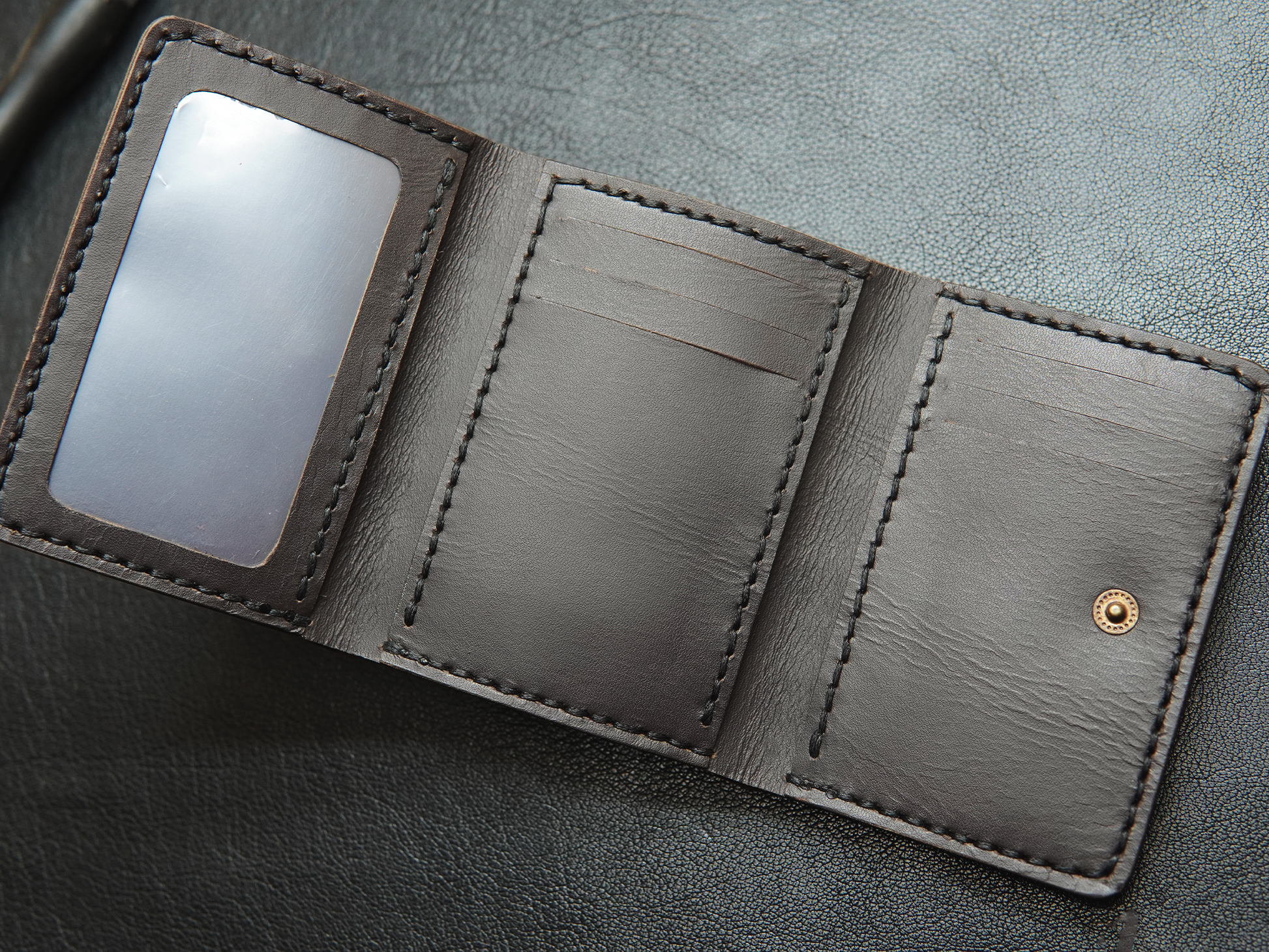 Inside view of Trinity wallet featuring 3+ 3 card slots, clear ID window, and hidden compartments