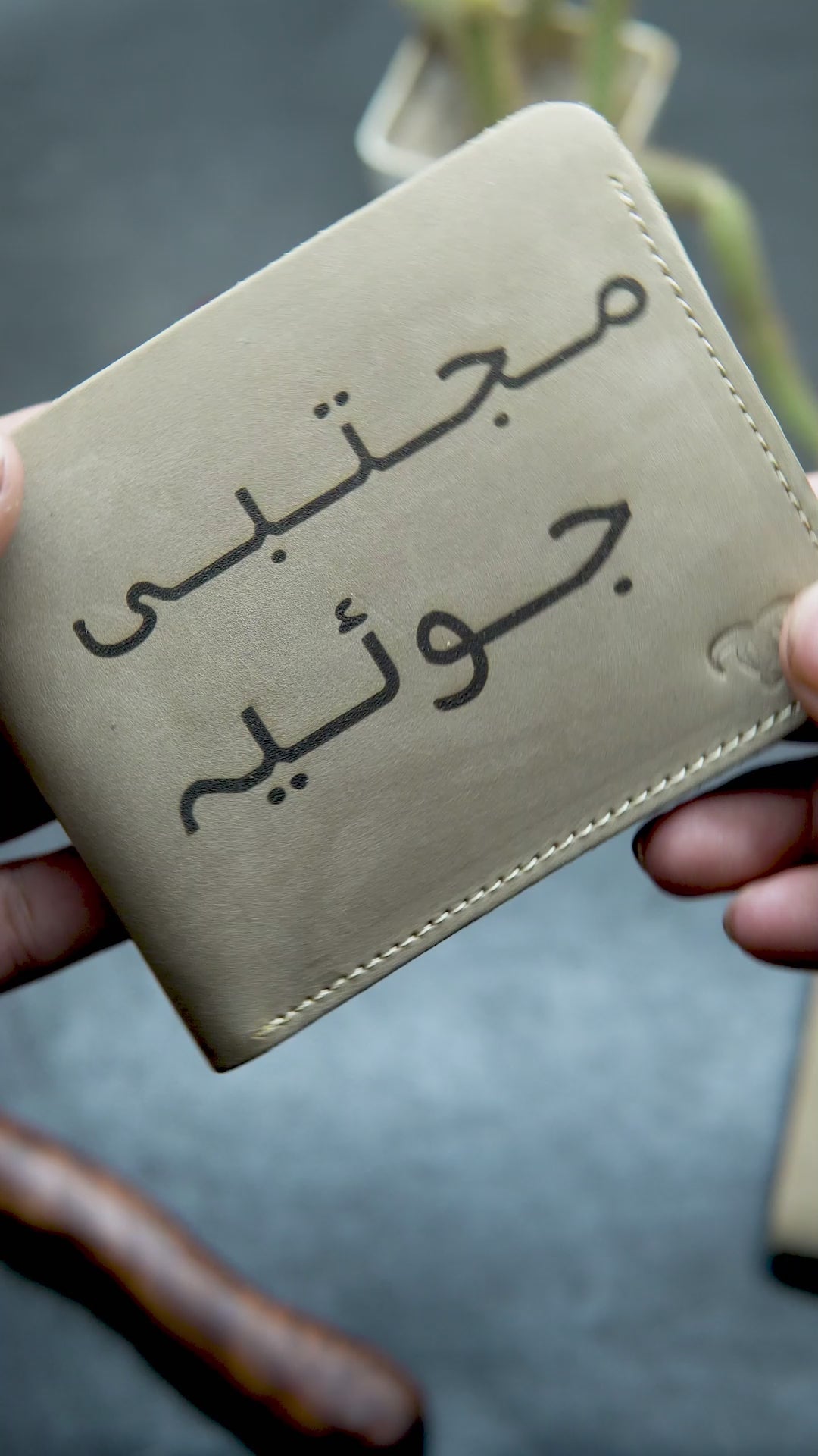 video showing the detail view of beige customize leather wallet