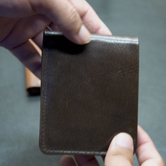 Video showing BOVIDAS FoldClassic brown leather wallet with 8 card slots, 2 hidden ID compartments, and full-length cash section in daily use

