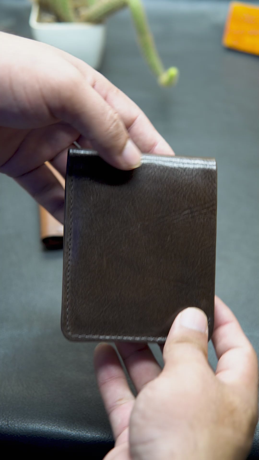 Video showing BOVIDAS FoldClassic brown leather wallet with 8 card slots, 2 hidden ID compartments, and full-length cash section in daily use

