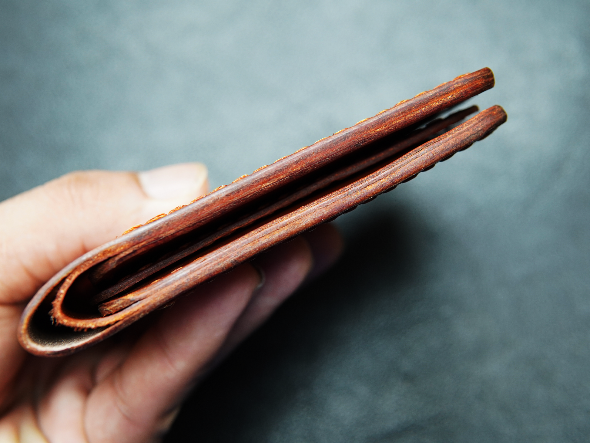 Side view of handcrafted brown leather wallet 